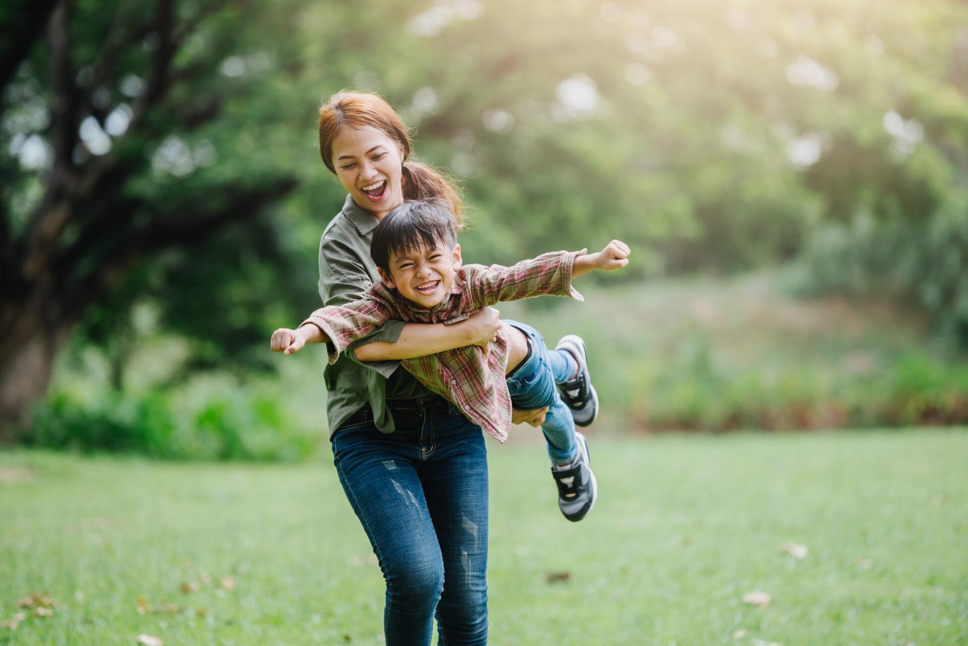 happy harmonious family outdoors concept.mother and son have act Happy mother and child playing outdoors.