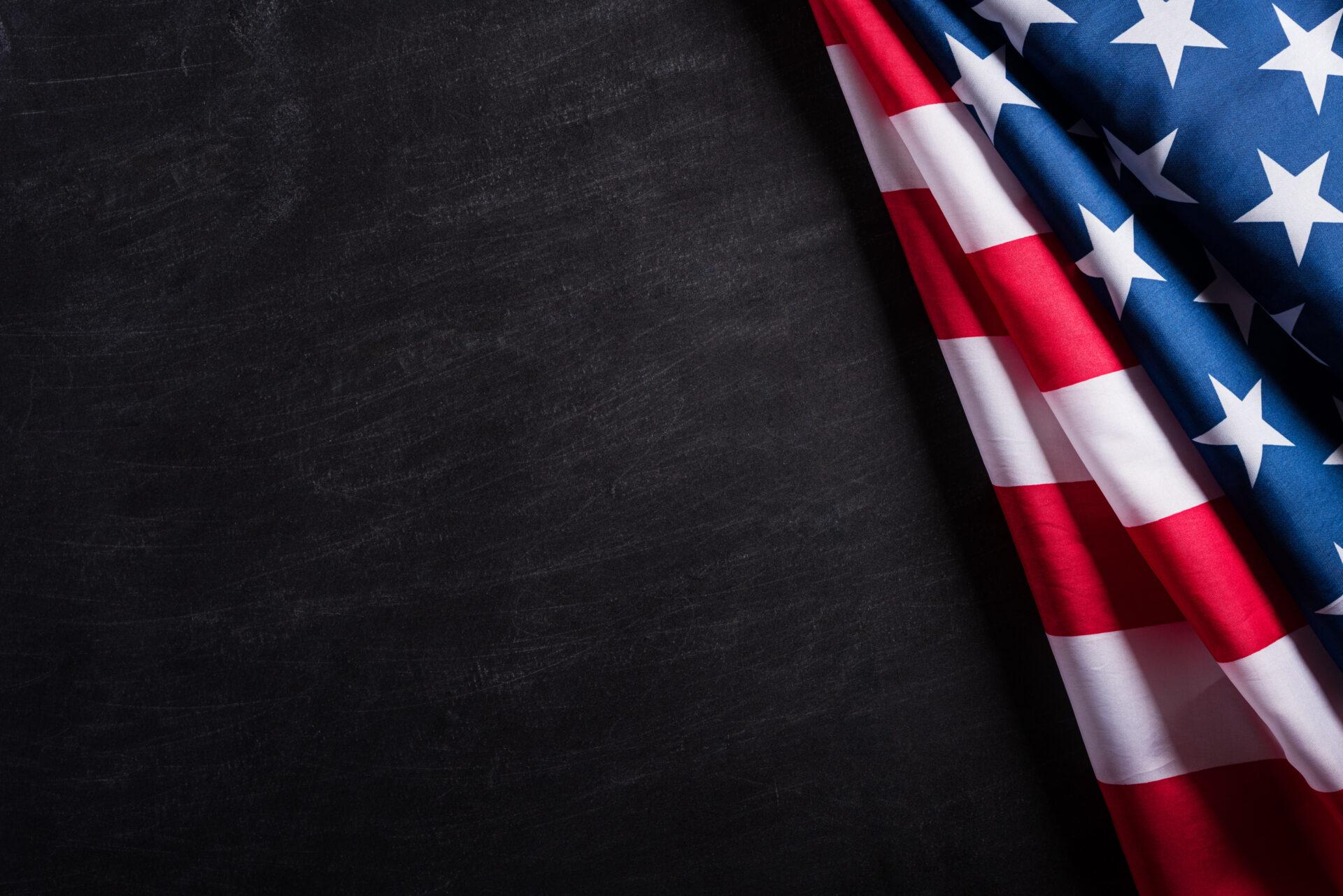 Happy Veterans Day. American flags veterans against a blackboard Flag background