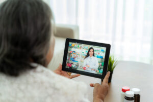 A woman talking to a doctor on a tablet